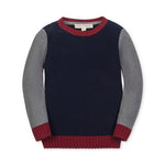 Children's sweater with navy body, gray sleeves, and red cuffs and hem on a white background.