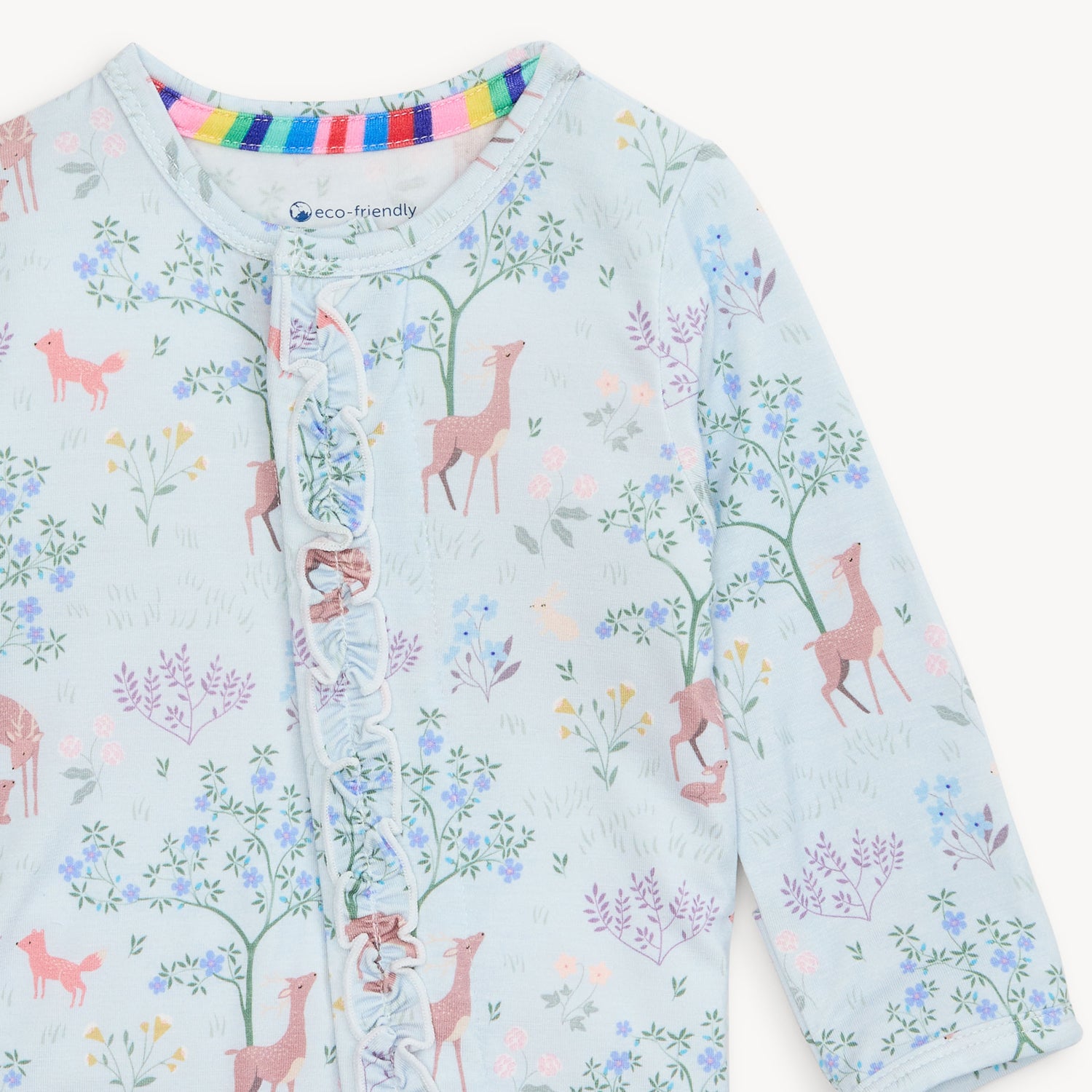 Children's outfit with deer and floral pattern on a light blue background