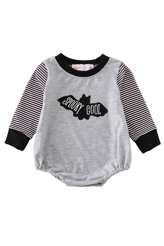 A gray baby bubble romper with black stripes on the sleeves and a graphic text 'SPOKY COOL' on the front.