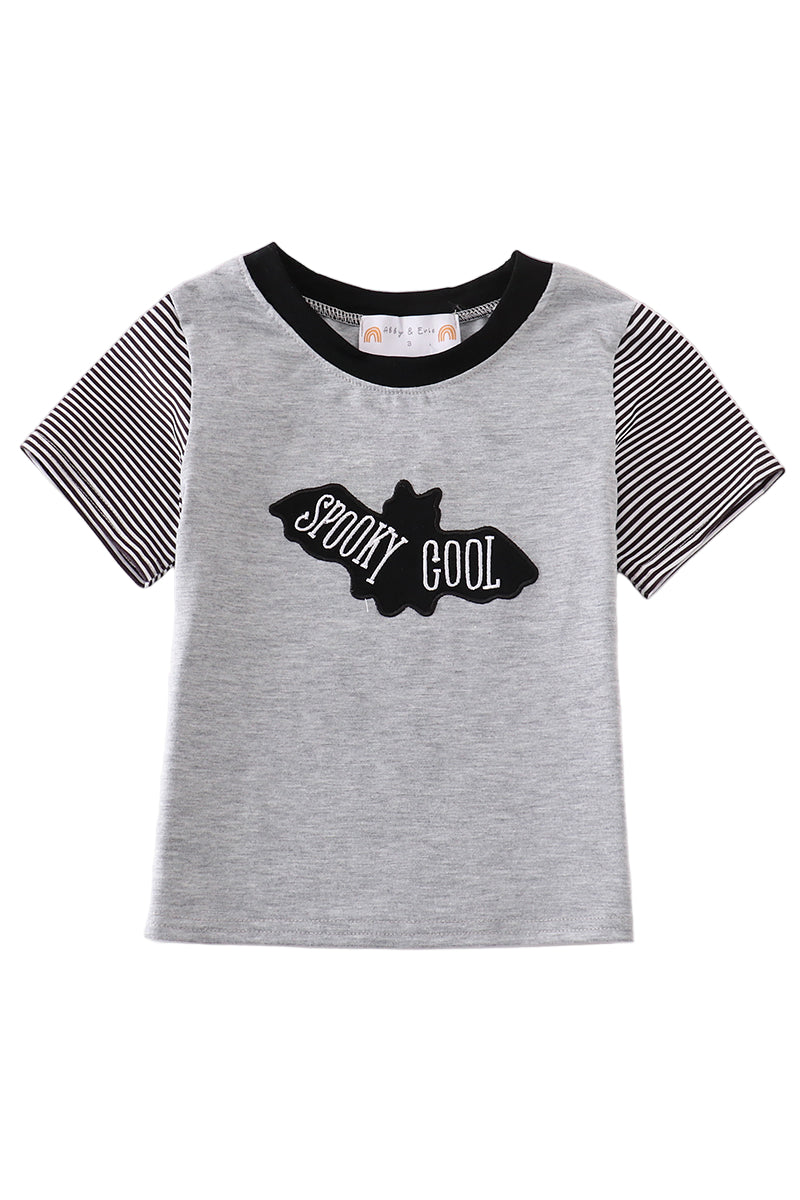 A short-sleeved gray t-shirt with black stripes on the sleeves and a graphic that reads 'SPooky COOL' with a bat silhouette.
