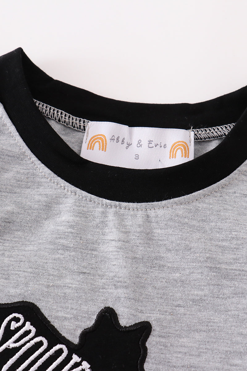 Gray sweatshirt with black cat design and brand label on a white background