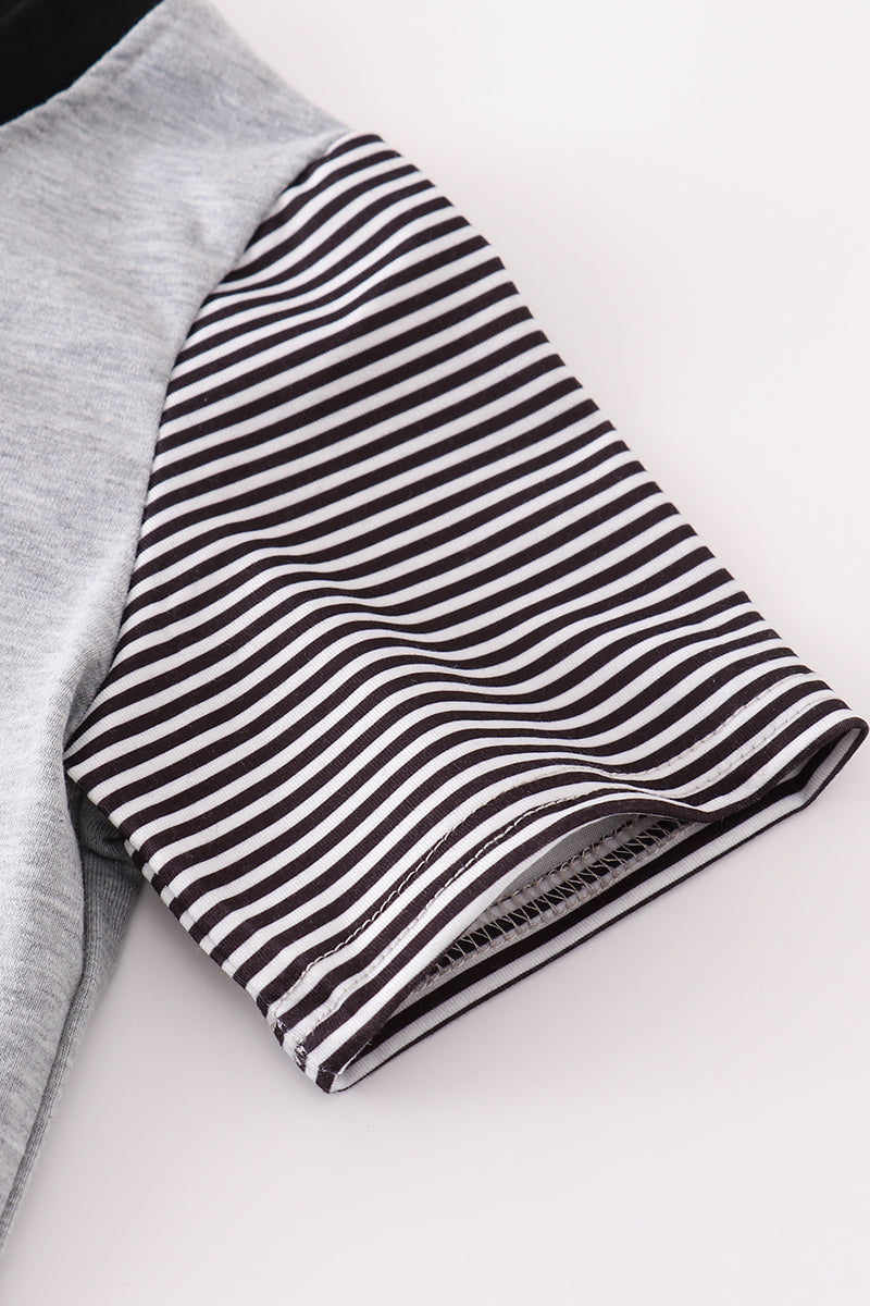 Black and white striped fabric on a gray garment with a white background