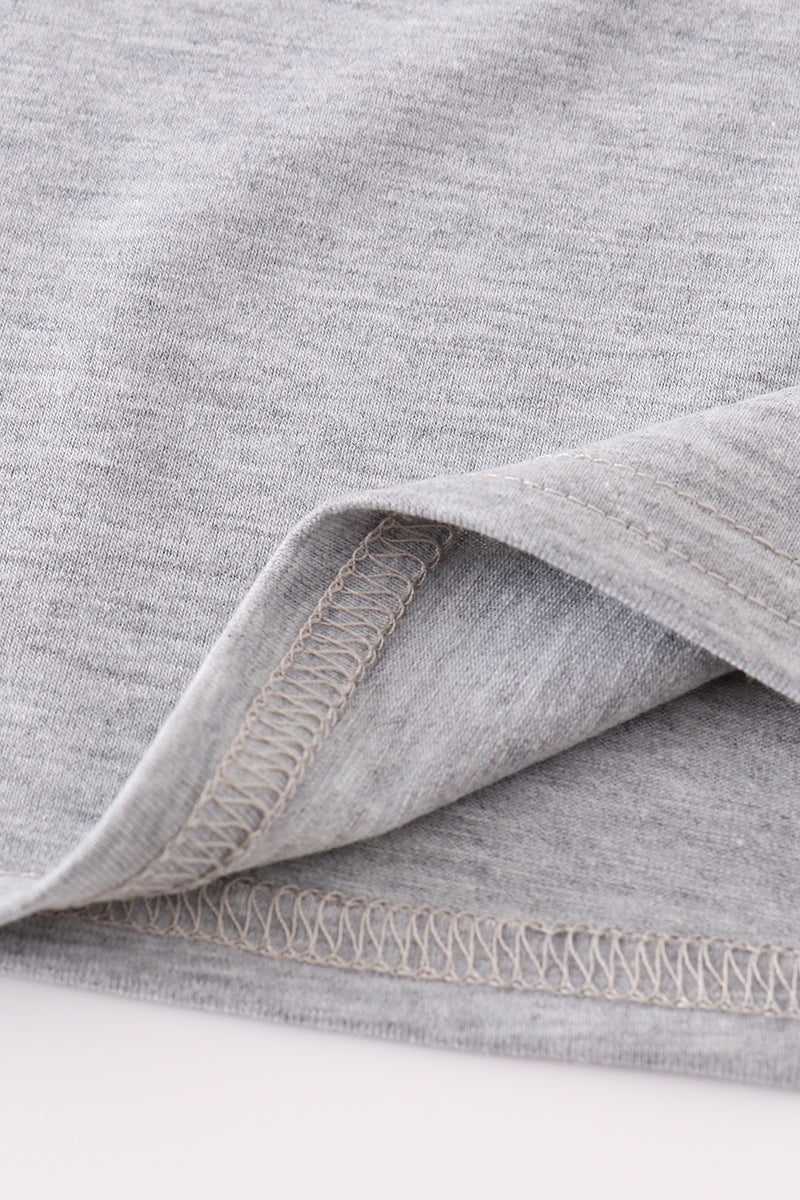 Close-up of gray fabric with a visible seam on a white background