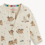 Baby footie with Where the Wild Things Are print showing magnetic closure on a white background