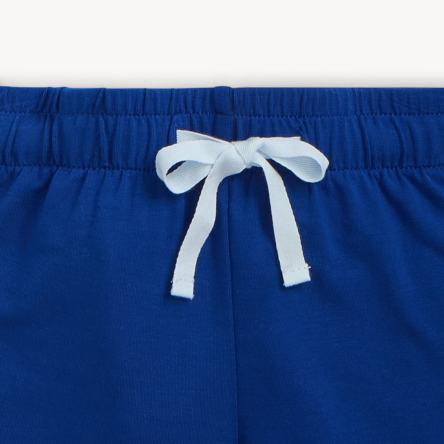 Blue shorts with a white drawstring on a white background