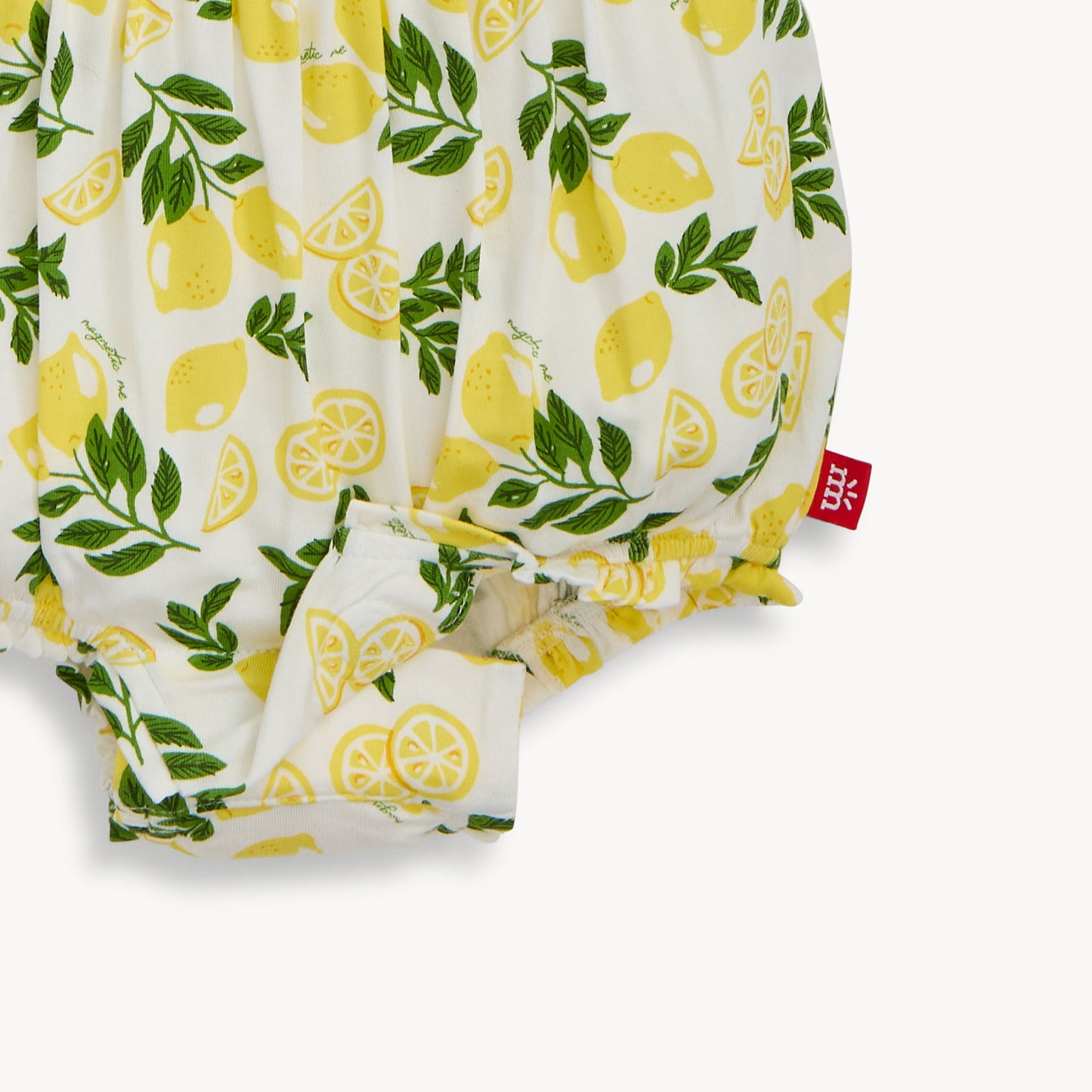 bubble romper with lemon and leaf pattern on a white background