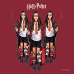 Person wearing a Harry Potter-themed outfit with robes, tie, and socks on a red background.