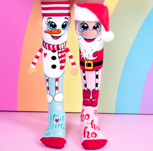 Two festive socks with a snowman and Santa design on a colorful background