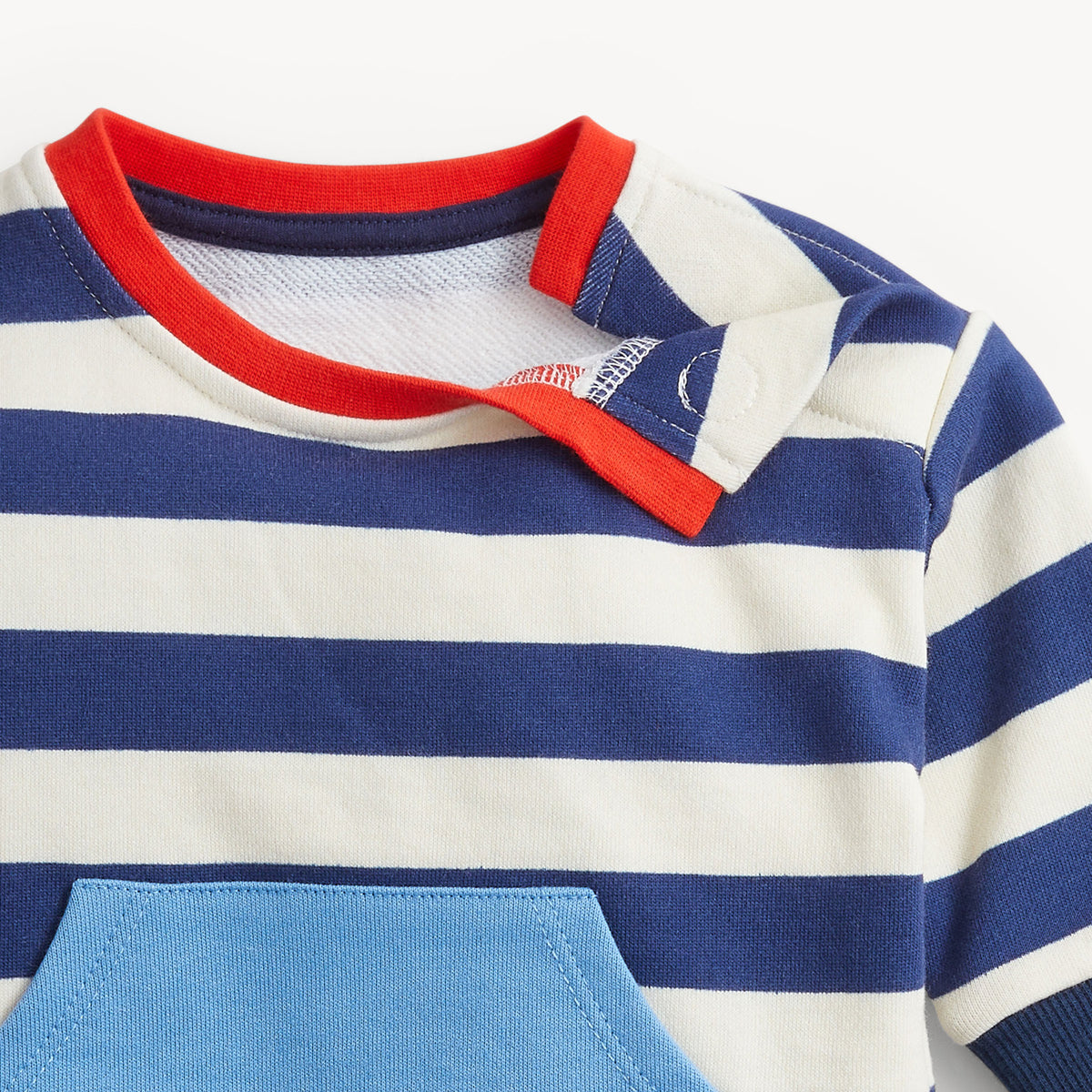 Close-up of a children's shirt with blue and white stripes and red collar on a light gray background
