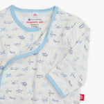 Baby wrap with airplane pattern and blue trim on a white background