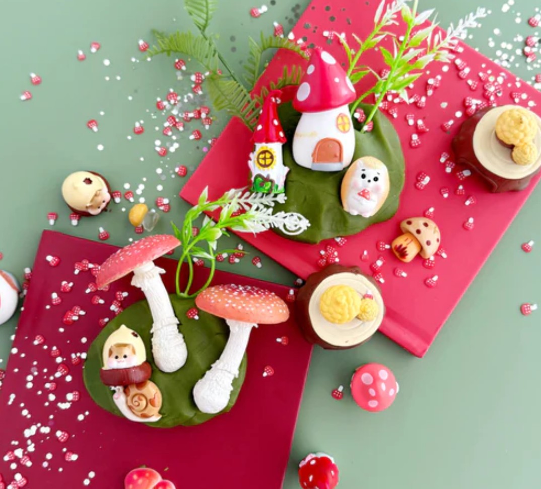 Decorative Christmas ornaments with gnomes, mushrooms, and snowmen on a red and green background.