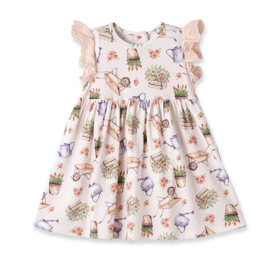 Children's dress with gardening-themed print on a white background