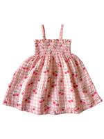 Pink checkered dress with cherry pattern on a white background