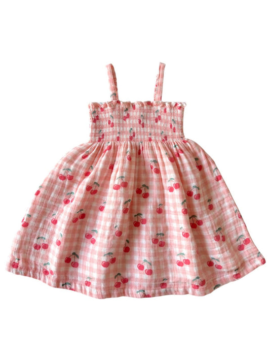 Pink checkered dress with cherry pattern on a white background