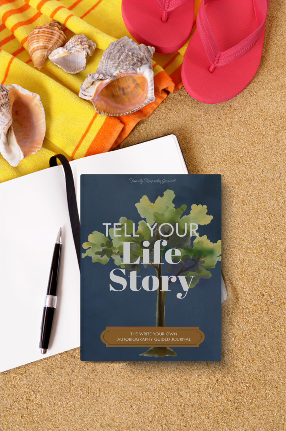 Book titled 'Tell Your Life Story' on sand with shells and flip-flops