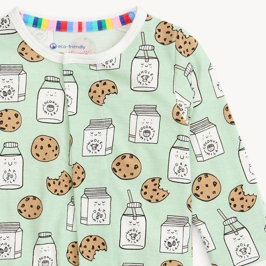 baby footie with cookie and milk pattern on a light green background
