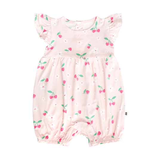 Pink baby romper with cherry pattern on a white background