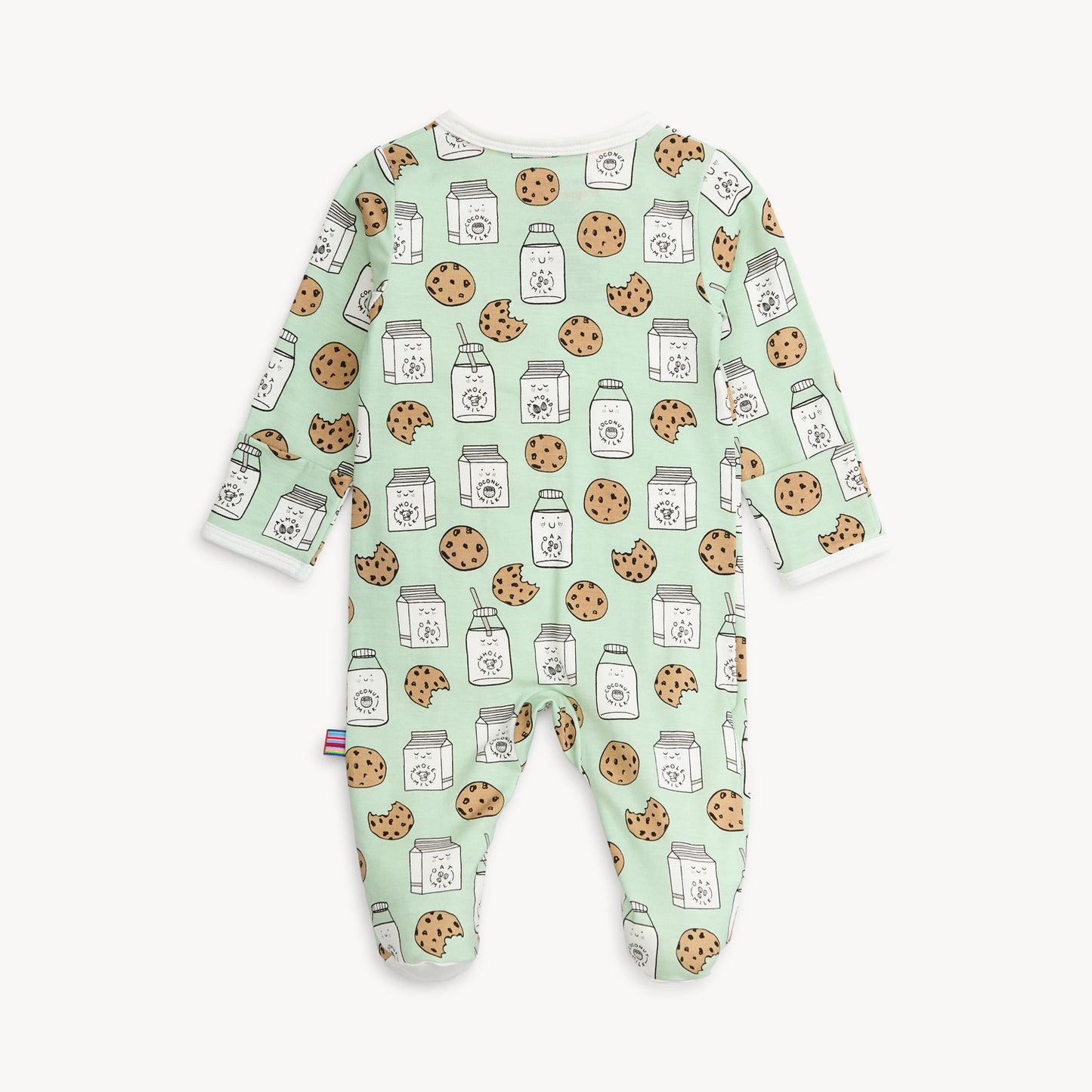 back of baby footie with cookie and milk pattern on a light green background
