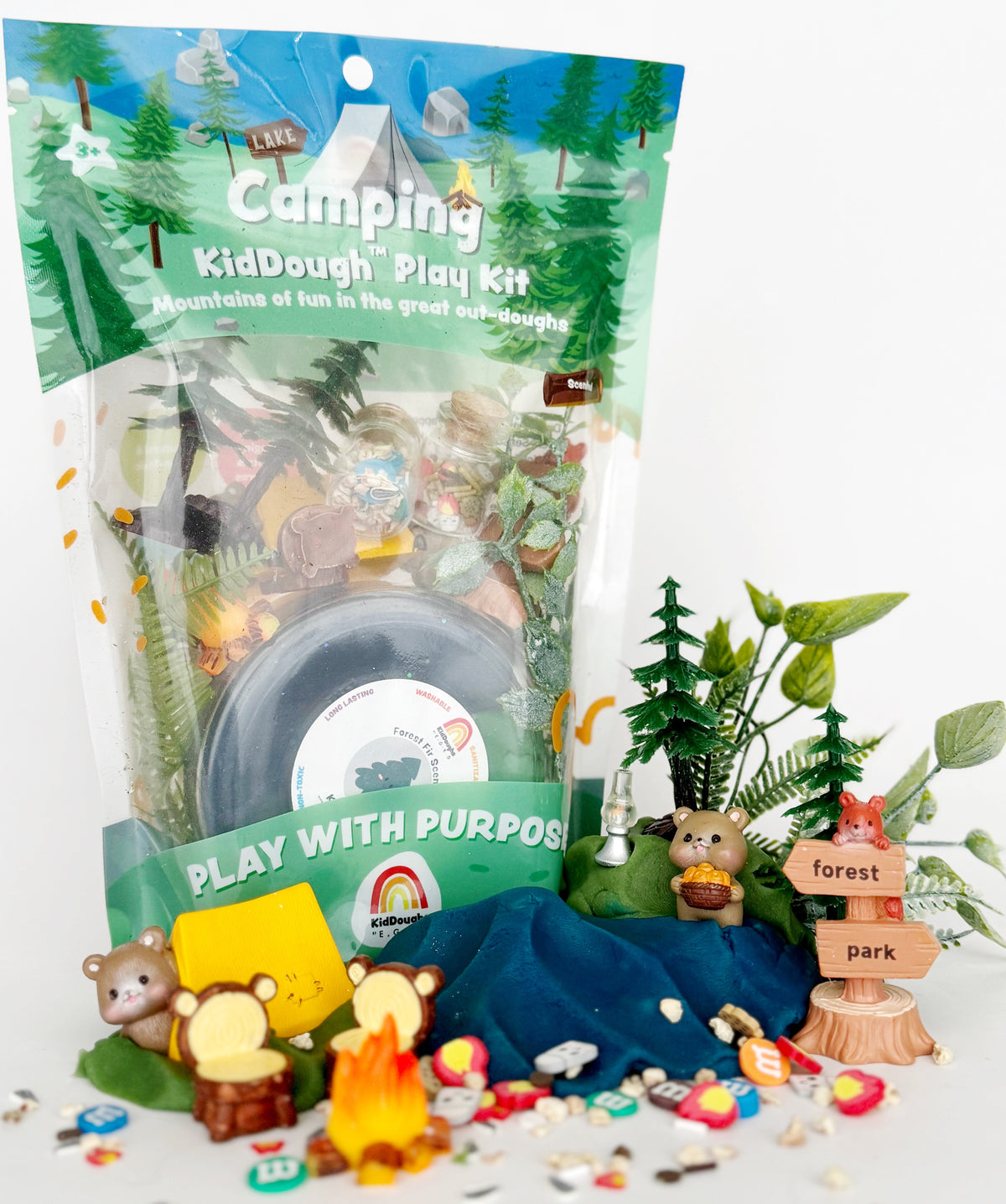 Camping-themed play kit with toys and accessories on a white background