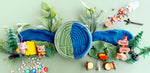 Play-doh with a forest scene setup on a light green background
