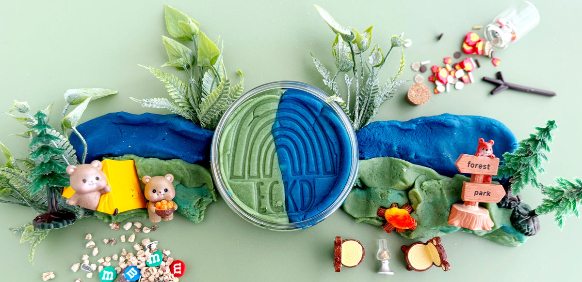 Play-doh with a forest scene setup on a light green background