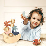 Child playing with a wooden toy set on a light background
