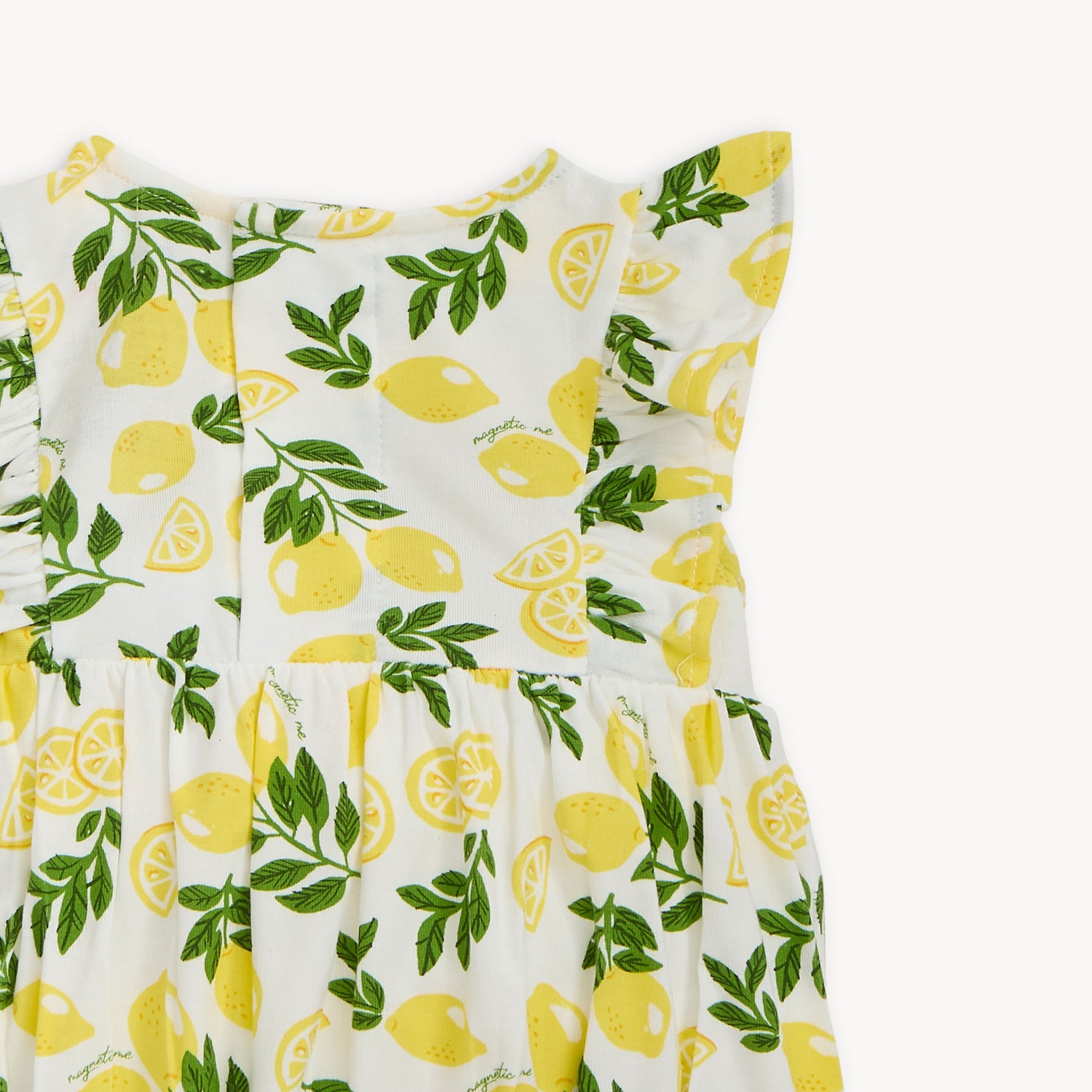 close-up of sleave ruffle with lemon and leaf pattern on a white background