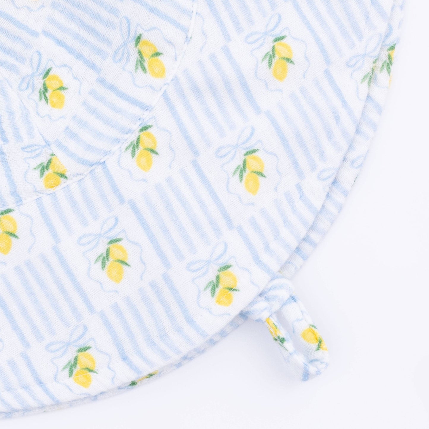 Fabric with lemon pattern on a blue and white striped background
