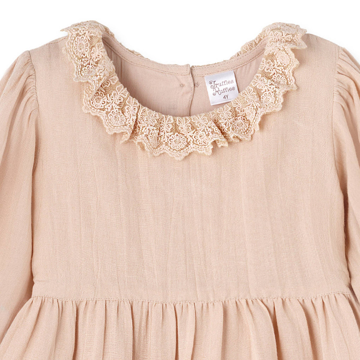 Beige dress with lace collar and 'Truffles Ruffles' label on a white background