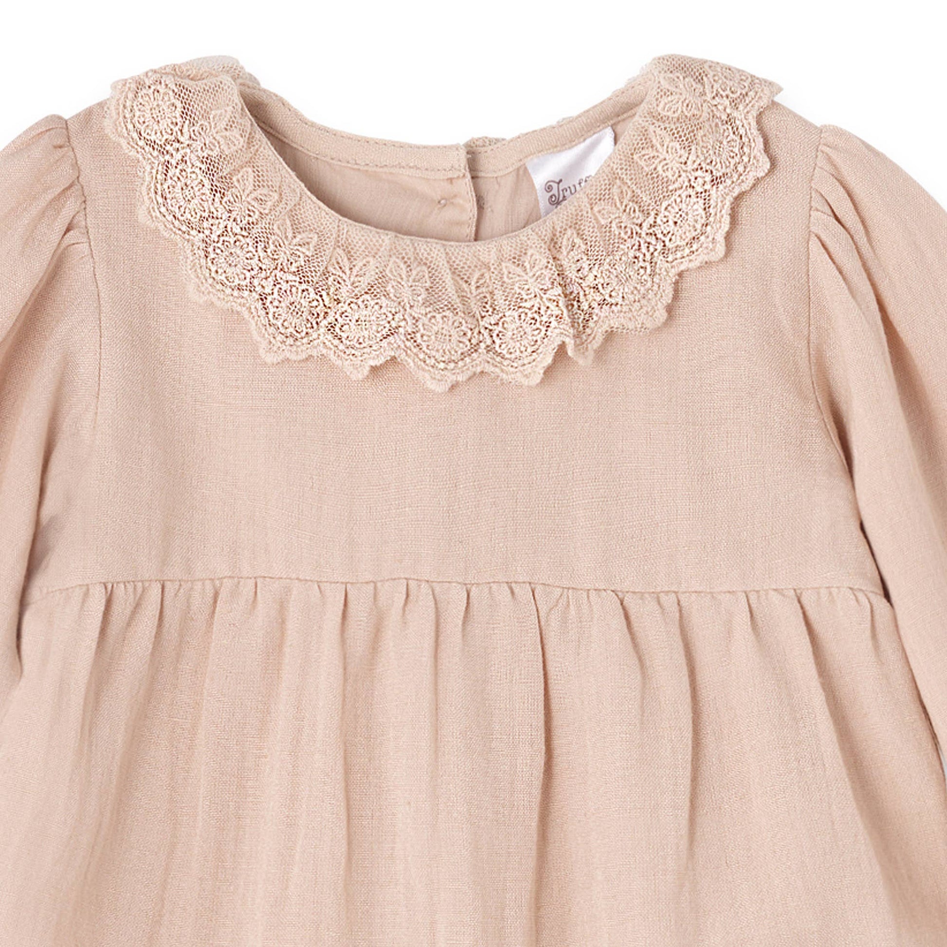 closeup of Beige baby rompers lace collar on a white background
