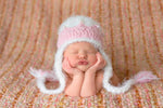 cute newborn baby first photo in pink and white princess hat