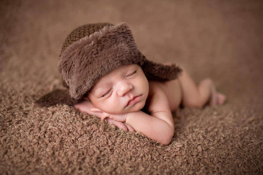 cute newborn baby first photos with brown aviator hat