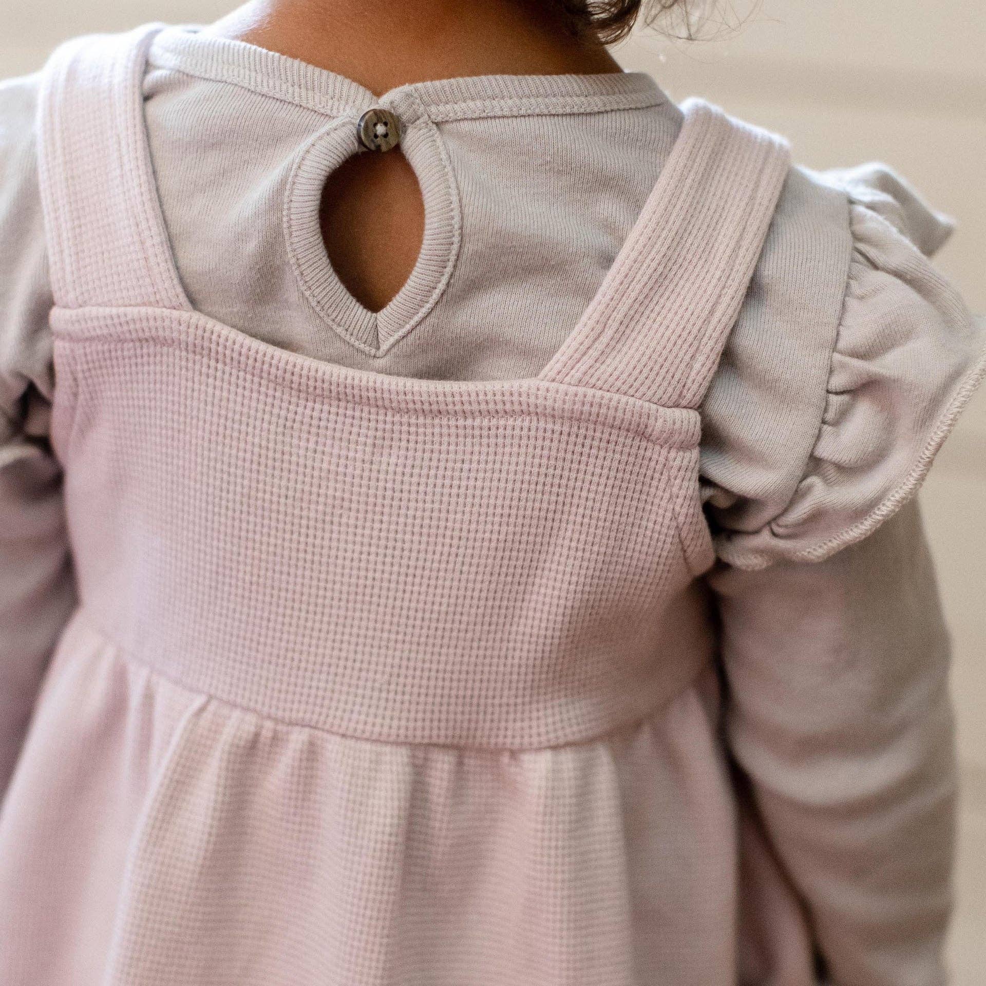 Back of pink dress close-up on a neutral background