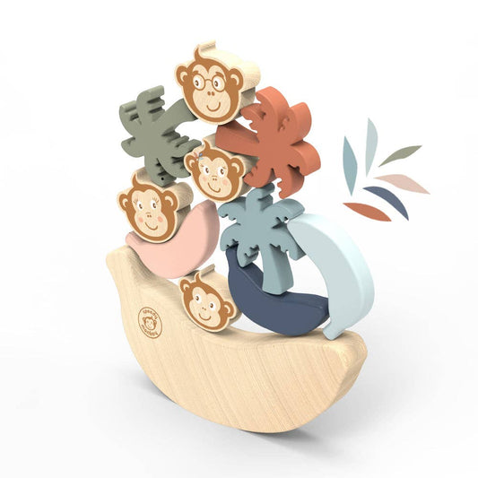 Colorful wooden toy with monkey figures and a banana on a white background