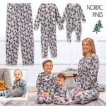Family wearing matching nordic pines themed pajamas