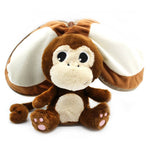 Plush monkey toy with a coconut shell on a white background