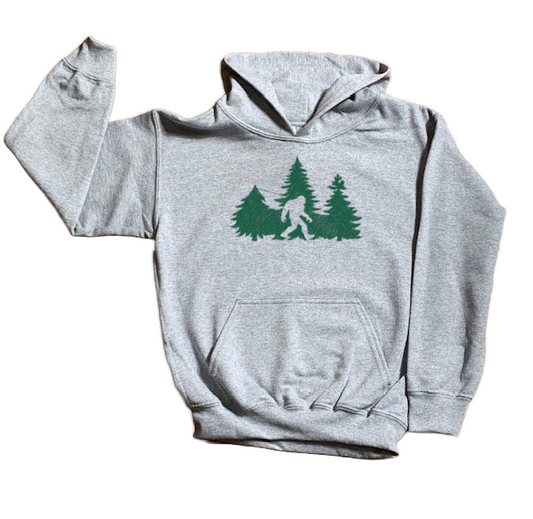 Gray hoodie with green graphic of a forest and Bigfoot on a white background