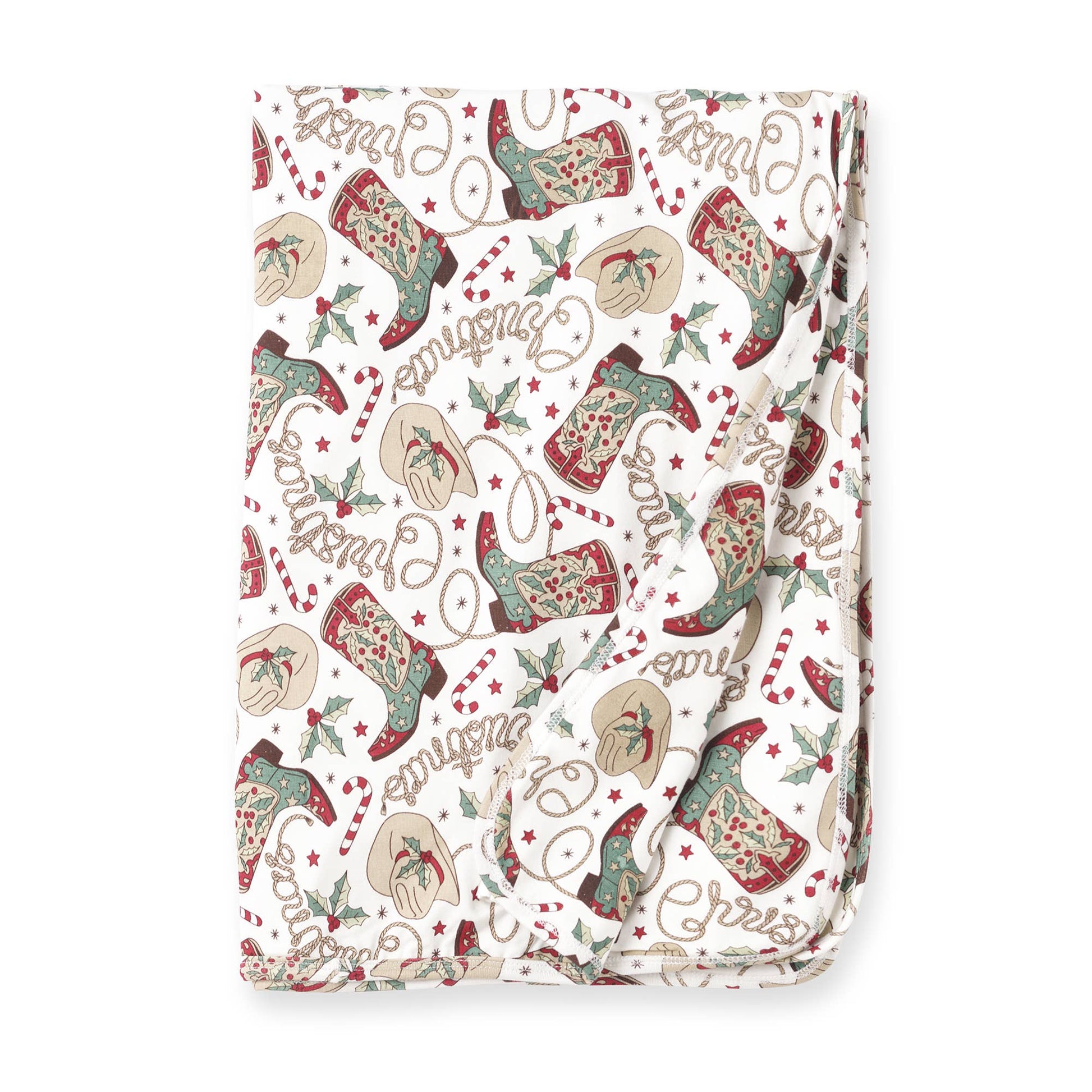 A folded Christmas-themed baby bamboo stroller blanket with a pattern of boots, berries, and holiday greetings on a white background.