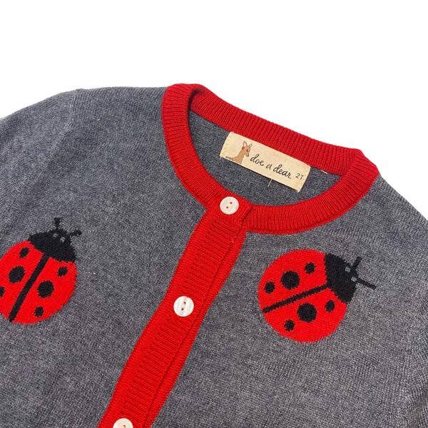 Gray cardigan with red trim and ladybug designs on a white background