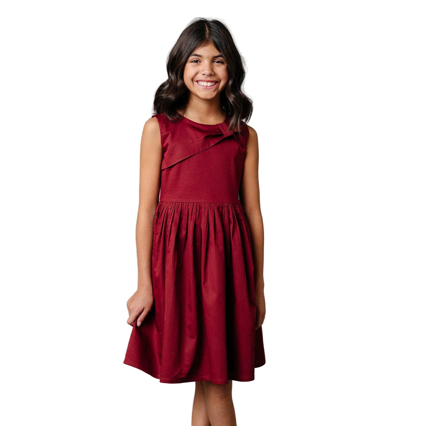 Young girl wearing a red dress against a white background