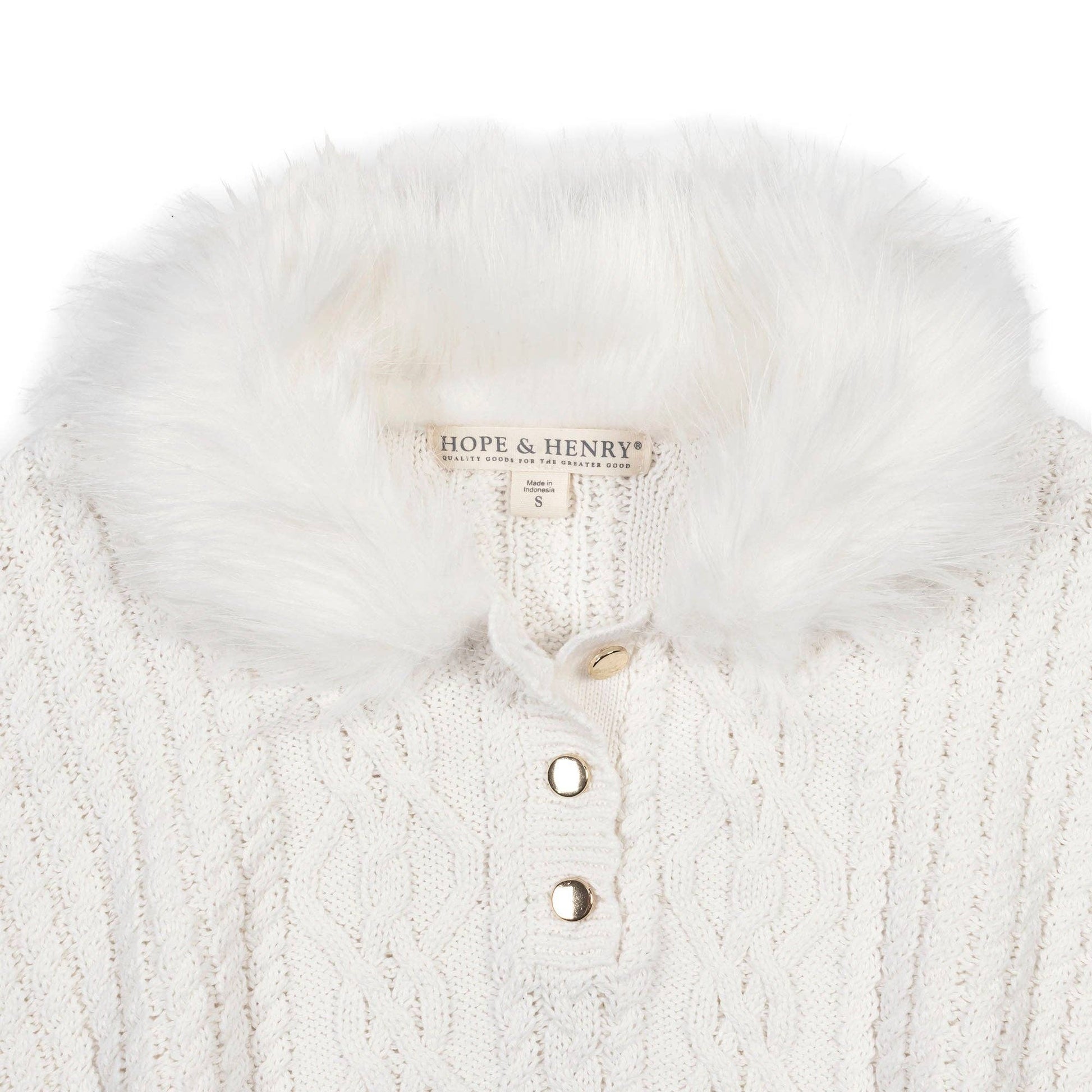 White knitted cape with fur trim and 'Hope & Henry' label on a white background