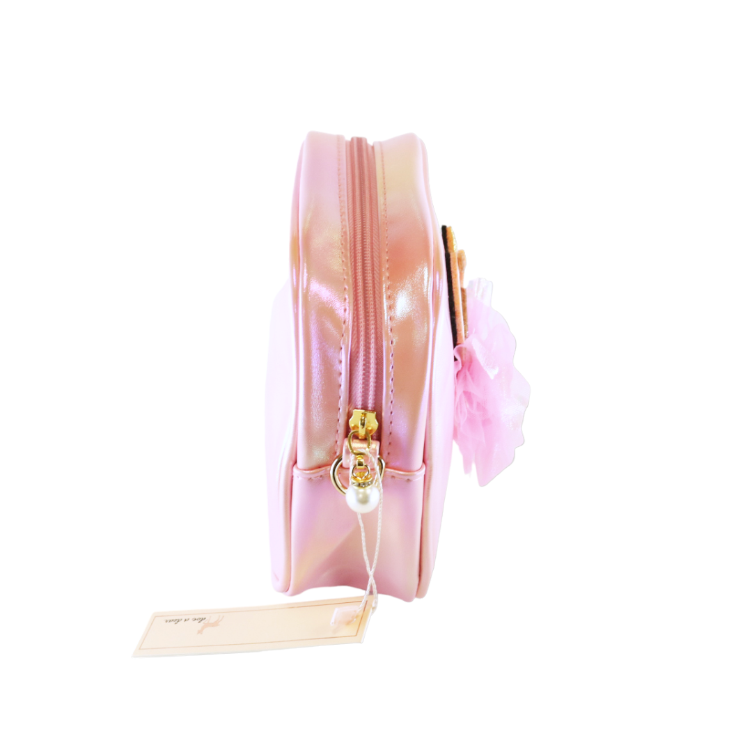 Pink and gold purse with a tag on a white background