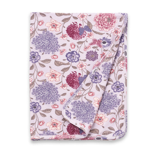 Floral patterned blanket with purple and pink flowers on a white background