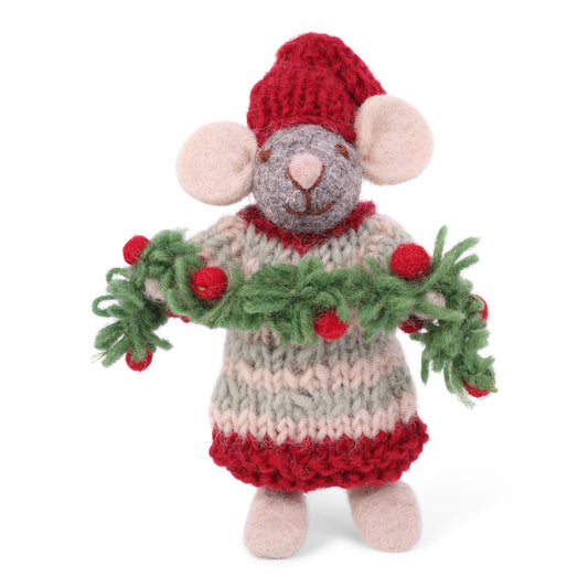 A handmade knitted mouse doll wearing a red hat and dress, with a green garland draped around its neck, photographed on a clean white background.