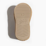 Beige shoe sole with brand logo on a white background