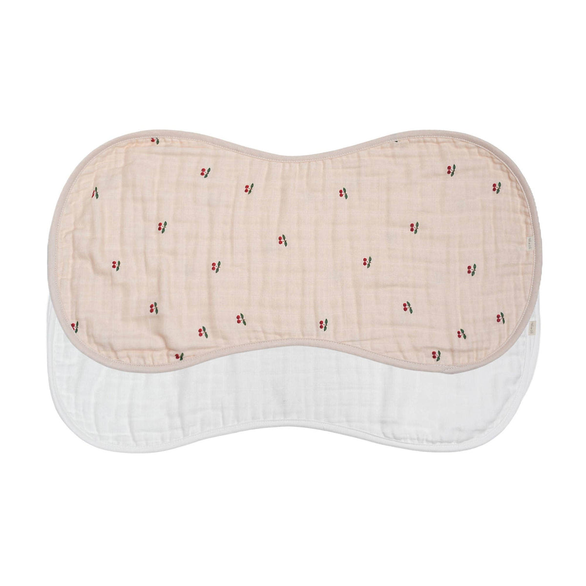 Pink with cherry print and white burp cloths laid flat on a white background