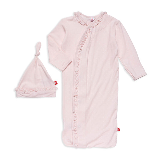 Pink baby gown with ruffles and matching hat on a white background
