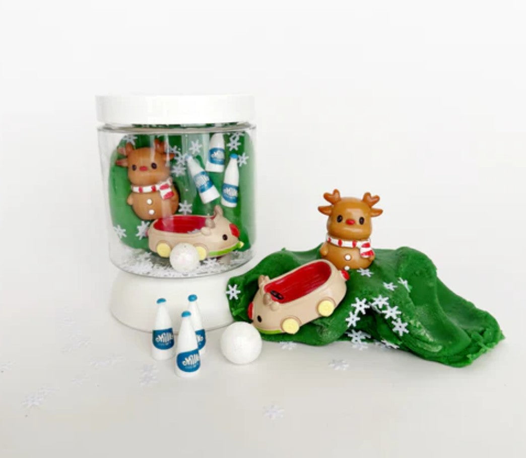 Set of Christmas-themed figurines including reindeer and a sleigh on a white background.