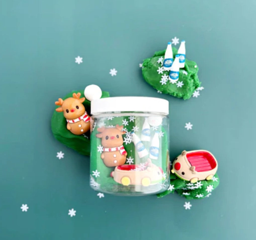 Decorative jar with small figurines on a teal background