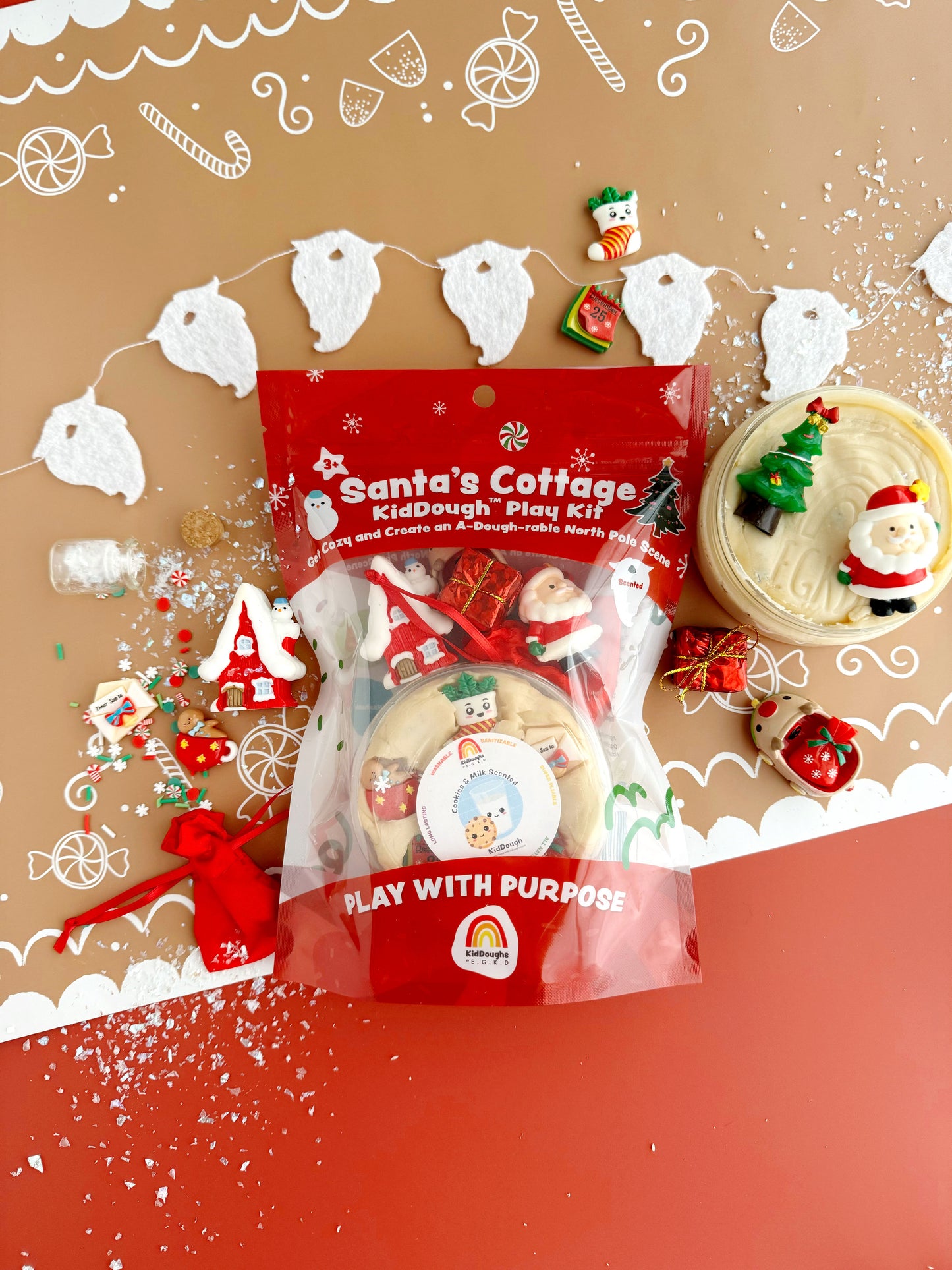 Santa's Cottage KidDough Play Kit packaging with Christmas-themed decorations on a brown background